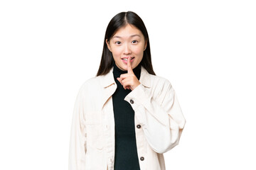 Young Asian woman over isolated chroma key background showing a sign of silence gesture putting...