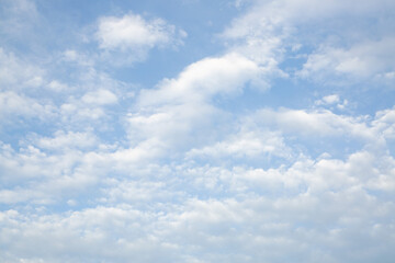 Blue sky with white light clouds. Cloud texture, background.