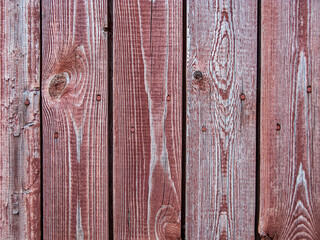 Old plank wooden wall made of boards. Old wooden boards with red nails with peeling paint abstract texture background.