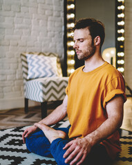 Hipster guy doing yoga to support flexibility and viability every day