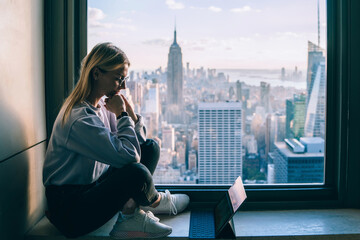 Hipster girl digital nomad working on modern tablet during travel
