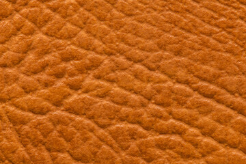 Closeup detail on orange leather texture background