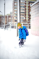 Adorable little boy having fun outdoors on beautiful winter day. Happy child playing outdoors.