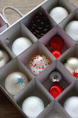 Boxes with various organized Christmas ornaments. Decorating or taking down the Christmas tree. Selective focus.
