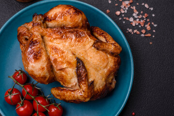 Crispy delicious whole baked chicken with vegetables, salt and spices