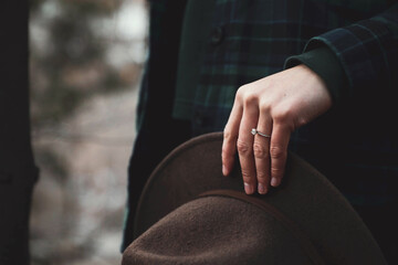 Close-up of hand holding a hat outside in Winter