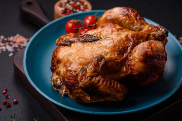Crispy delicious whole baked chicken with vegetables, salt and spices