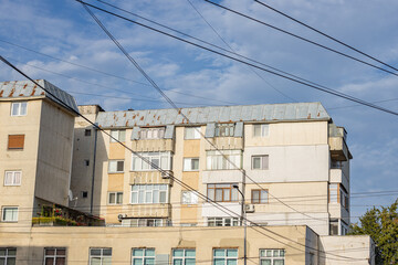 Fototapeta premium Old apartment block from communist era in Eastern Europe. Communist socialist architecture style flat. Dreary and depressive rust-eaten building.