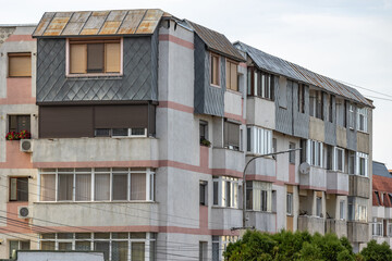 Obraz premium Old apartment block from communist era in Eastern Europe. Communist socialist architecture style flat. Dreary and depressive rust-eaten building.