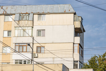 Old apartment block from communist era in Eastern Europe. Communist socialist architecture style flat. Dreary and depressive rust-eaten building.