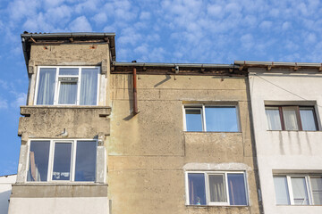 Old apartment block from communist era in Eastern Europe. Communist socialist architecture style flat. Dreary and depressive rust-eaten building.