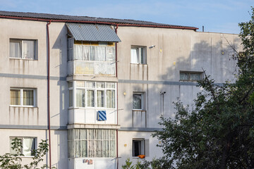 Old apartment block from communist era in Eastern Europe. Communist socialist architecture style flat. Dreary and depressive rust-eaten building.