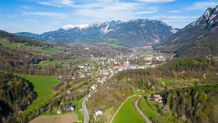 Fototapeta na wymiar Aerial view of beautiful rural village Reichenau in Austria with the mountain Rax in the background