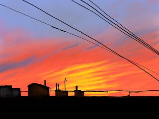 sunset on the roof of the house. urban evening landscape in bright colors