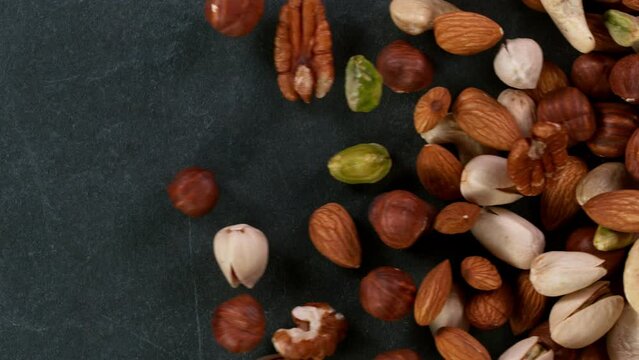 Super slow motion of moving mix nuts. Filmed on high speed cinematic camera at 1000 fps.