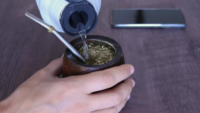 Water served into steaming yerba mate infusion