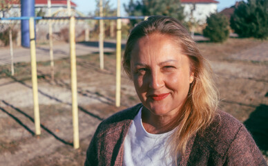 Obraz premium street portrait of a cute adult woman of European appearance, natural blonde, selective focus