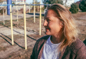 street portrait of a cute adult woman of European appearance, natural blonde, selective focus