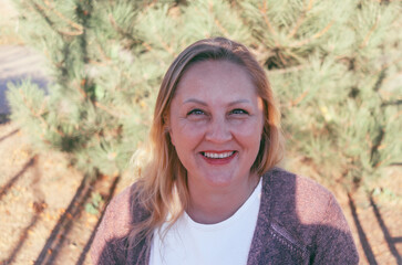 street portrait of a cute adult woman of European appearance, natural blonde, selective focus