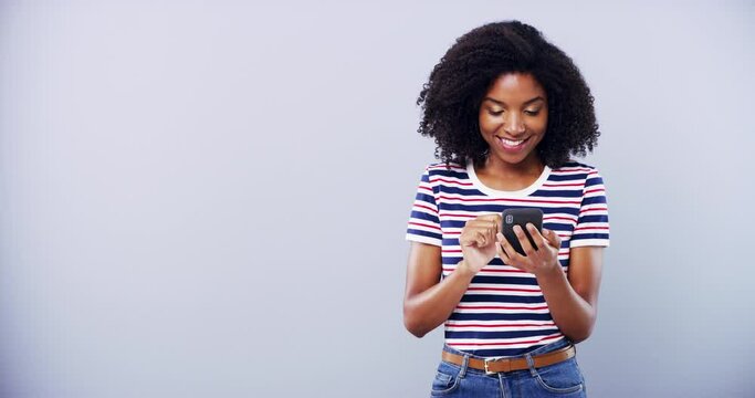 Black woman, typing on smartphone and happy in studio isolated on white background mockup space. Smile, phone and person scroll on mobile app, online dating or reading email, internet or social media