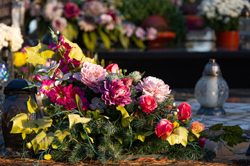 Flowers on grave. Graveyard in Poland. All saint's day.