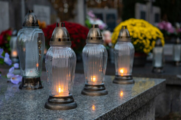 Candles on grave. Lanterns on cemetery. All saint's day.Poland