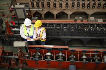 worker or engineer working in factory with safety uniform , safety hat and safety glasses , image is safety concept or happy workplace