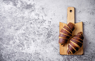 Croissants with chocolate crust and chocolate filling with cup of tea