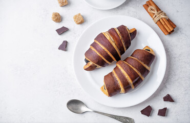 Croissants with chocolate crust and chocolate filling with cup of tea