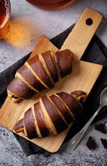 Croissants with chocolate crust and chocolate filling with cup of tea