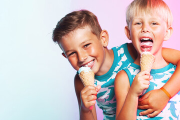 Tasty treat concept. Happy two young handsome brothers wearing sleeveless shirts with sharks,...