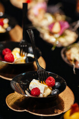 A pleasant evening with a delicious appetizer, a buffet table with appetizers and a set of canap s with ham, bruschetta, pear, cheese, raspberries and other sweets.