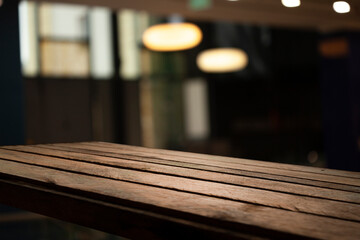 empty table to showcase your product on blurred golden bokeh cafe background. window bokeh