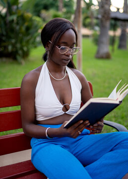 African American woman reading in garden
