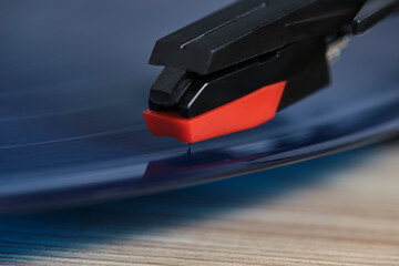 Needle of vinyl player is mounted on record. Closeup on macro photos.