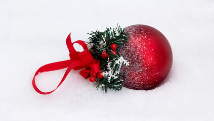 Elegant Christmas Ornament, a decorated Christmas ball rests in the snow, creating a Christmas atmosphere. Merry Christmas and happy new year holiday celebration concept.