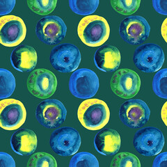 Seamless pattern of hand painted watercolor abstract circles. Blue, green and yellow circle design elements on a green background.