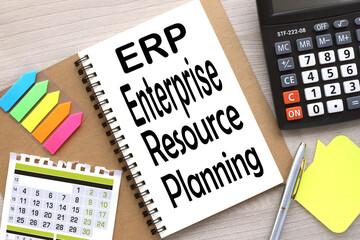 ERP. open notebook with stickers and a calendar for the month. word on the page