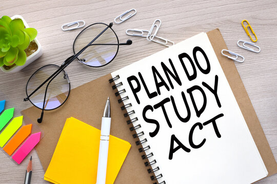 Plan Do Study Act top view of an open notebook with stickers and plants in a pot. word on the page