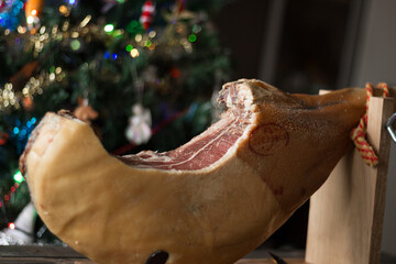 Whole Serrano ham on a Christmas tree background