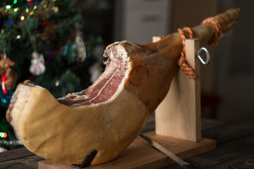 Whole Serrano ham on a Christmas tree background