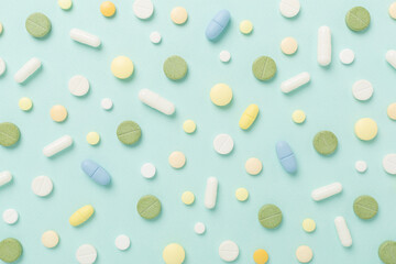 Flat lay with different medical pills and capsules on color background