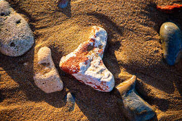 sea sand and stones on the beach at sunset