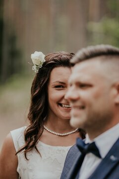 The bride gazes lovingly at the groom, her portrait captured in soft focus, emphasizing her radiant and affectionate expression.