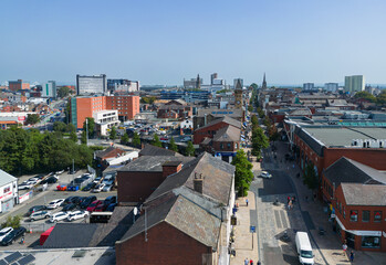 Fototapeta premium Preston, Lancashire, UK, September 06, 2023; high aspect aerial view of Fishergate high street shopping and over the town cityscape of Preston, Lancashire, England.