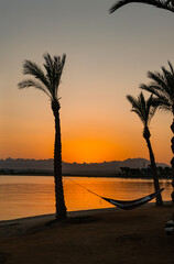 Orange Egyptian Sunset over the mountains and Red Sea resort with reflection, Soma Bay, Hurghada, Egypt