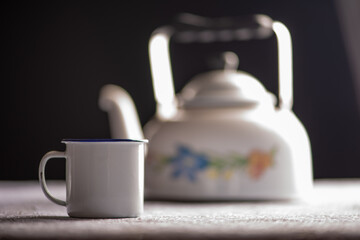 Coffee table, a simple coffee table with utensils on a lace tablecloth, dark background, selective focus.
