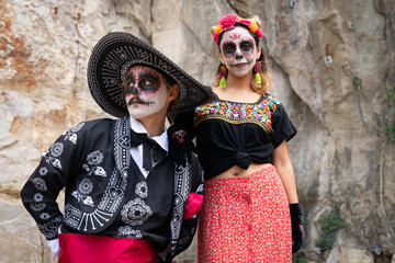 Portrait of mexican couple dressed as catrines. Day of the dead