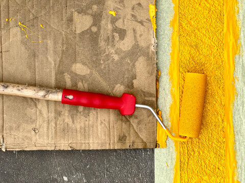 Paint roller on a yellow line