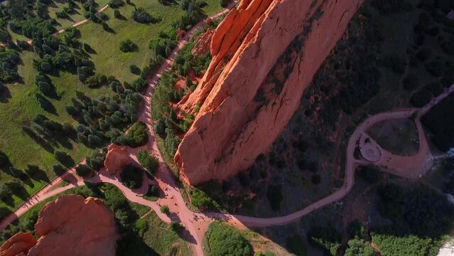 Aerial Forward Tilt Up Shot Of People Amidst Rock Formations Near Road Against Sky - Colorado Springs, Colorado